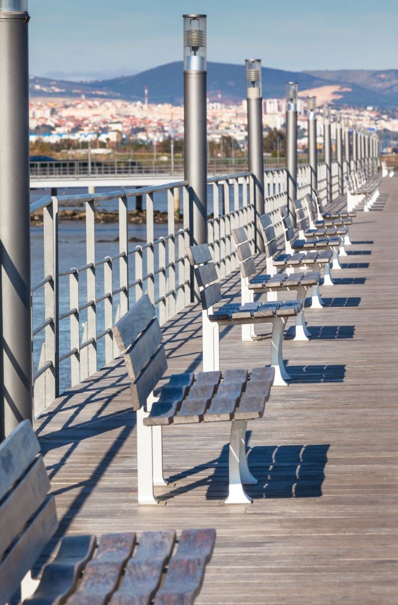 Wooden Benches Row at River Embankment. Vertical shot